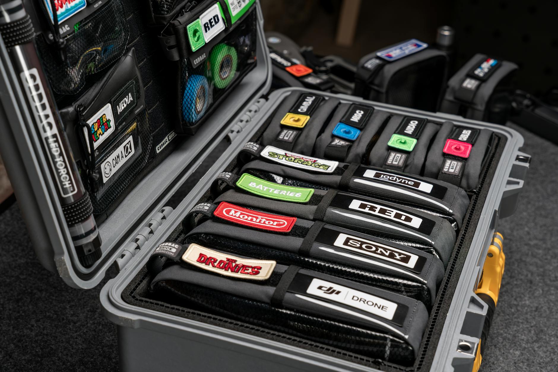 Compact hard case with labeled photography equipment for easy transport.