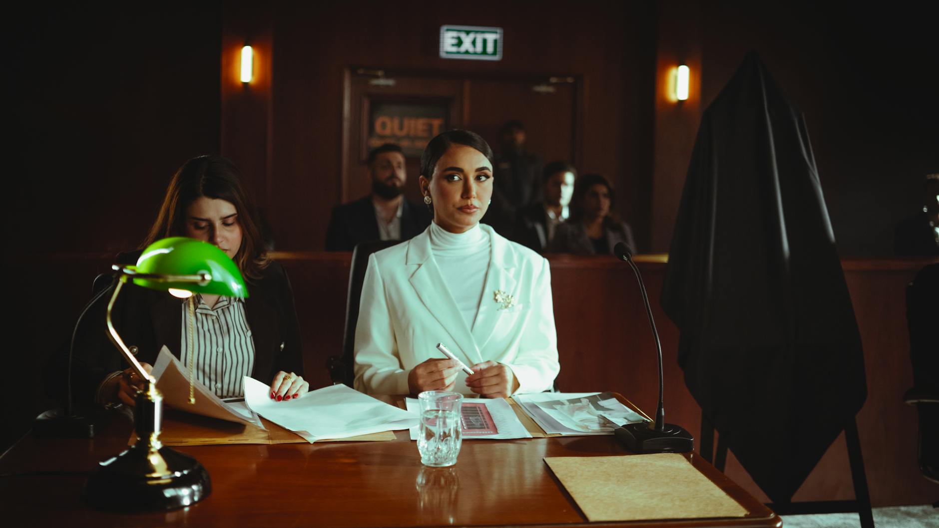 A courtroom scene in Baghdad with lawyers and participants engaged in legal proceedings.