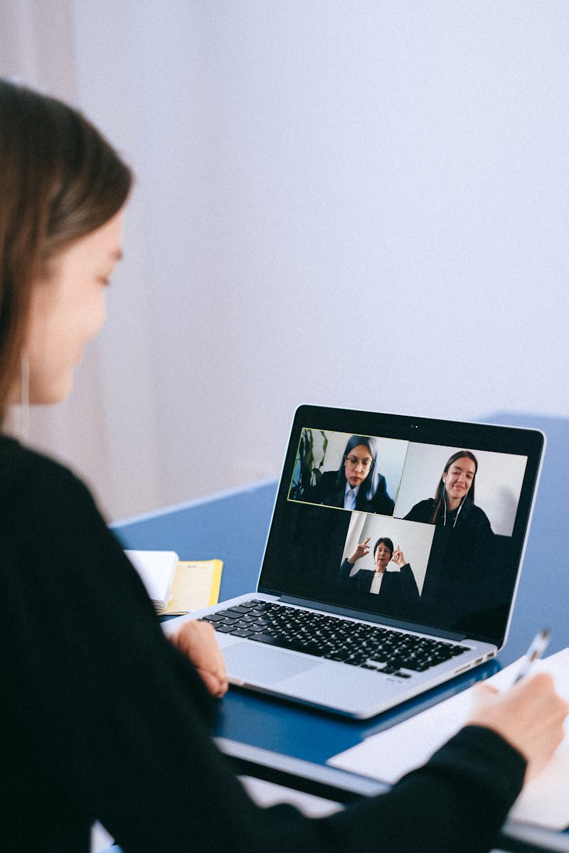 A person participating in a virtual conference on a laptop screen.